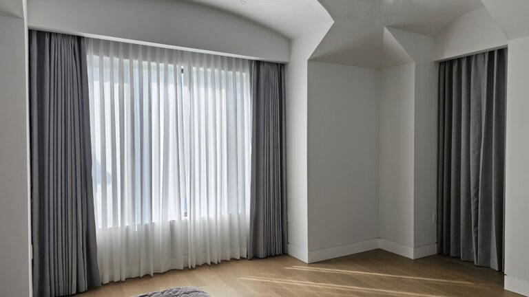 Custom drapery panels on floor to ceiling living room windows