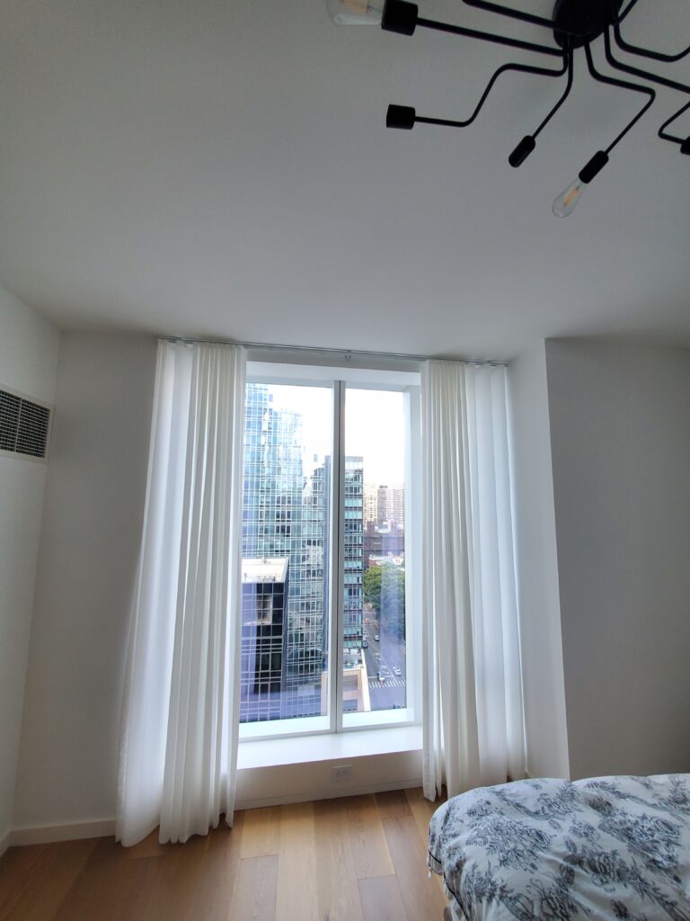 Custom drapery measured and fitted for a Bergen County living room across floor-to-ceiling windows