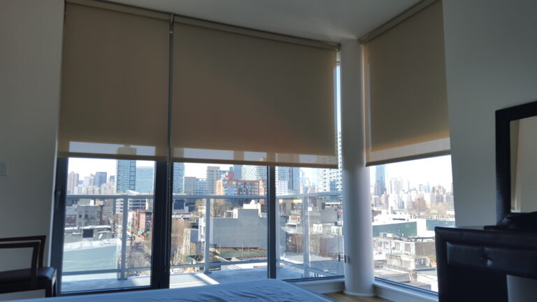 Roller shades in a Bergen County living room across floor-to-ceiling windows
