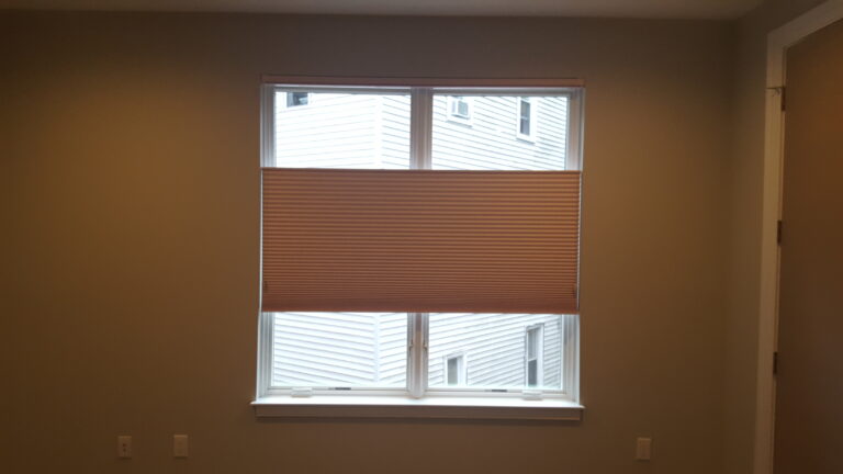 Duette Classic room-darkening honeycomb shades across a bedroom window