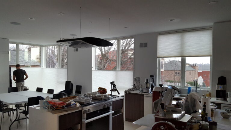 Applause honeycomb shades in a bright open plan kitchen with island seating