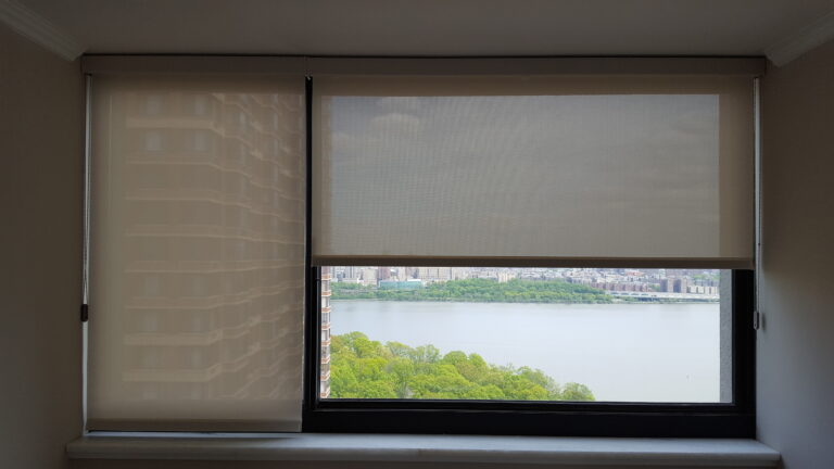 Oatmeal solar shades on a run of tall living room windows