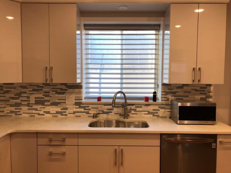 Shark grey zebra shade over a kitchen sink and tiled splashback