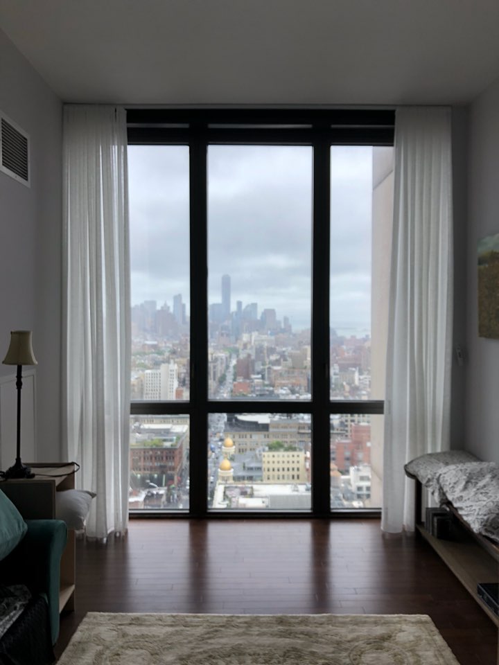 Sheer curtains white sheer curtains stacked either side of a floor to ceiling window in a high rise bedroom looking over the city