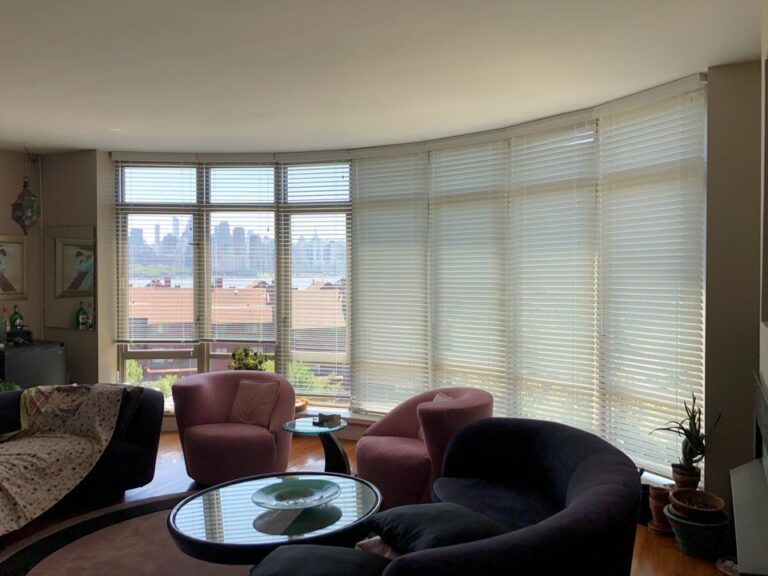 Wood blinds in a Bergen County living room across floor-to-ceiling windows