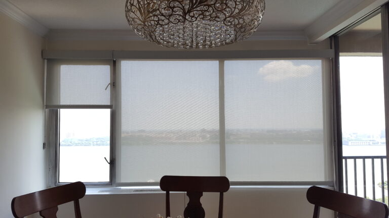 Solar shades on a tall stairwell and dining window