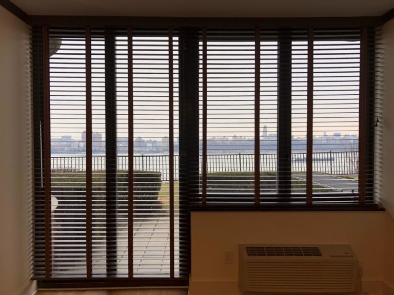 Parkland wood blinds fitted to a sliding patio door with a waterfront view