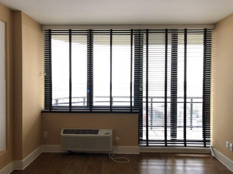 Wood blinds on full height living room windows