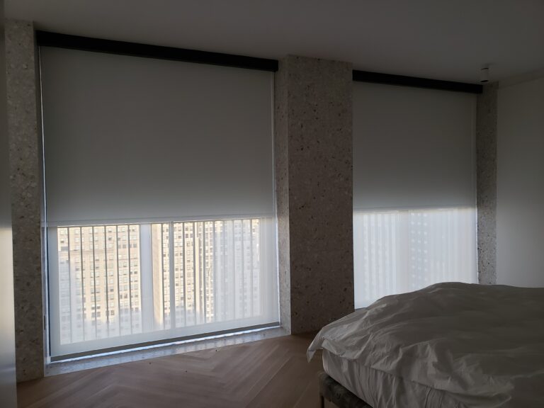 Roller shades in a Bergen County living room across floor-to-ceiling windows