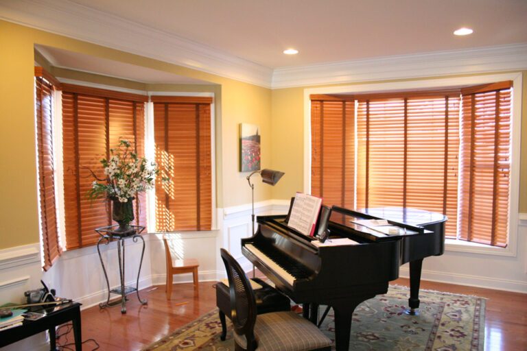 Wood blinds in a living room across a bay window in a Bergen County home