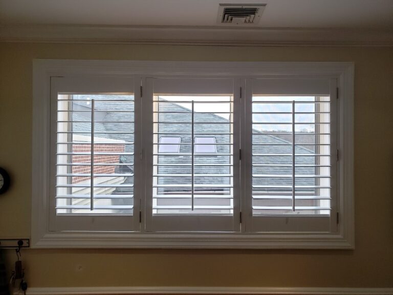 Plantation shutters closed across a run of three windows