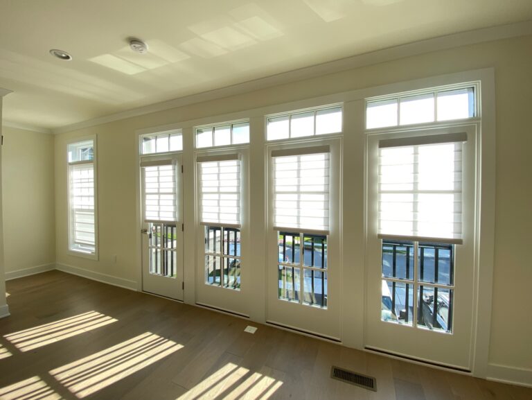Plantation shutters installed in a New Jersey living room in a bay window