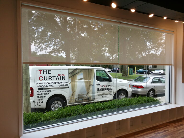 White solar screen shades across a large open commercial space