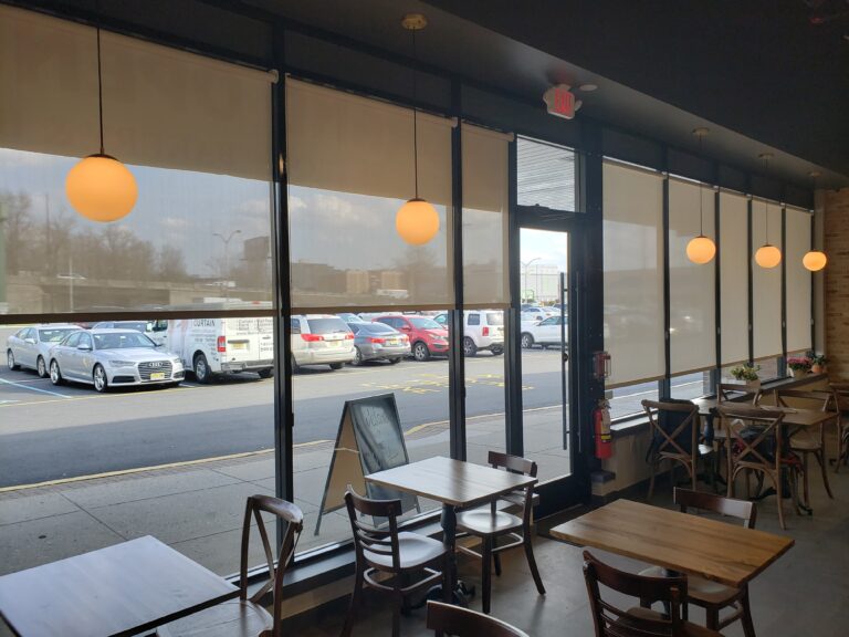 Roller shades in a Bergen County commercial space across floor-to-ceiling windows