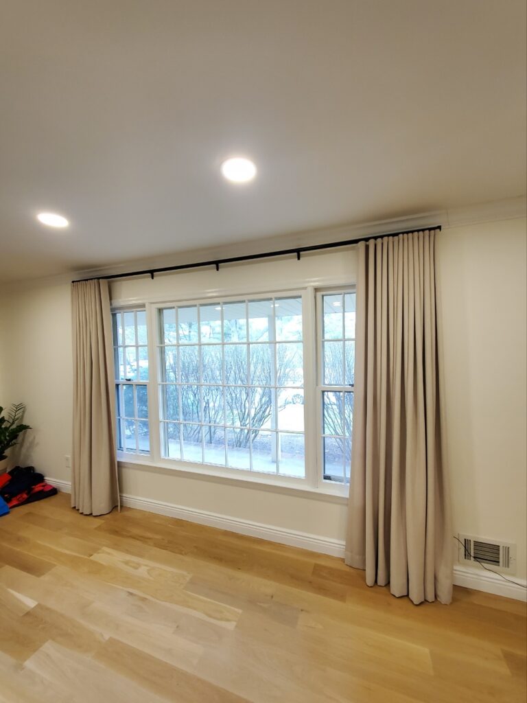 Custom drapery in a Bergen County living room across floor-to-ceiling windows