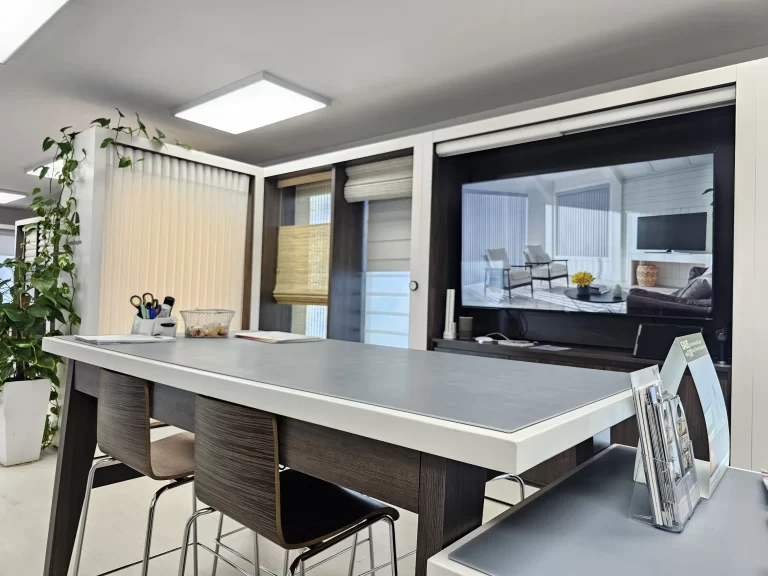 Inside The Curtain showroom in Palisades Park, with window displays and a work table