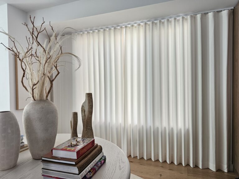 Custom drapery panels in a living room on floor to ceiling windows in a Bergen County home