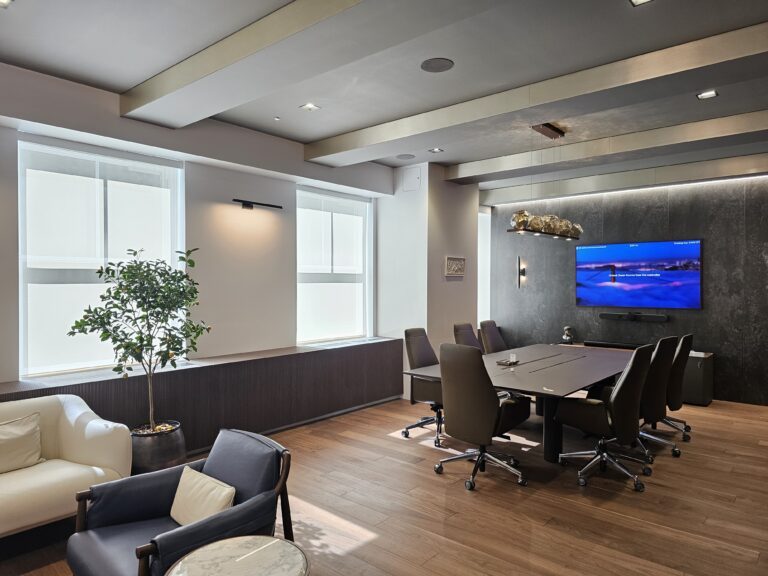 Solar screen shades fitted across an office window wall