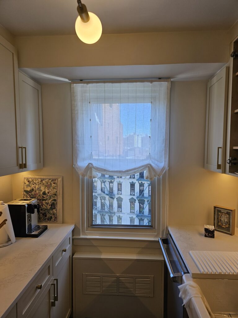 Custom drapery in a Bergen County dining room under an arched window