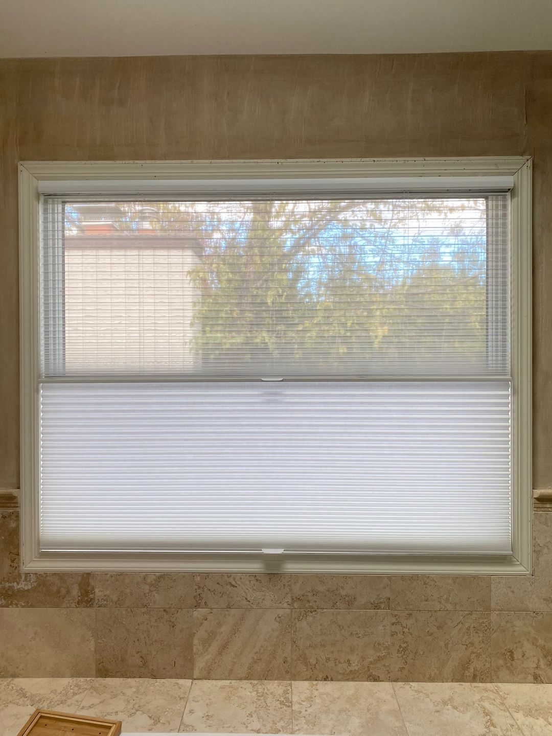 Top down bottom up honeycomb shade for privacy above a marble bathtub surround