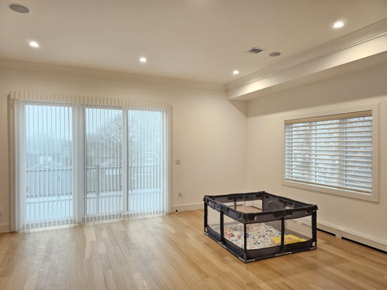Sheer zebra shades in a living room over a sliding glass door in a Bergen County home