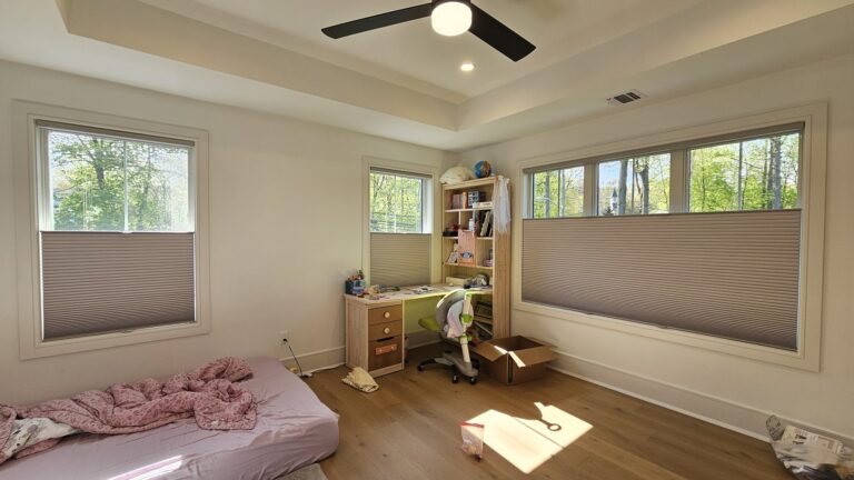 Cellular honeycomb shades in a bedroom