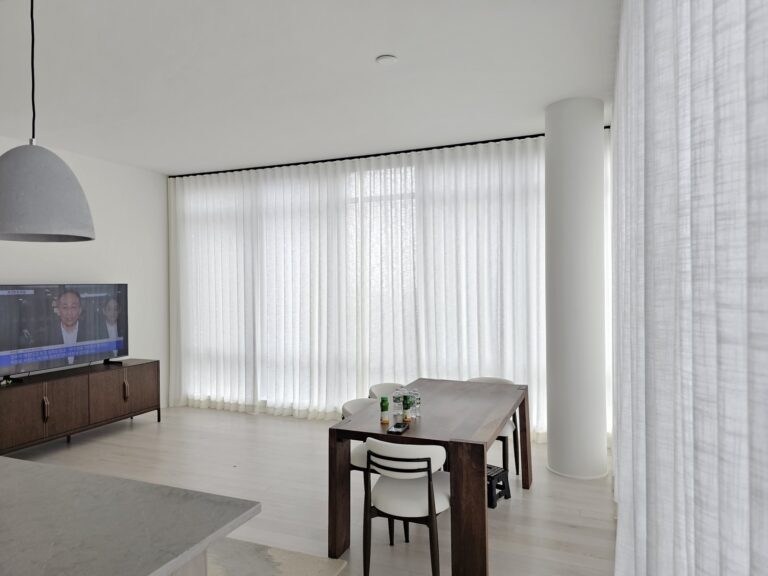 Custom drapery panels on floor to ceiling dining room windows