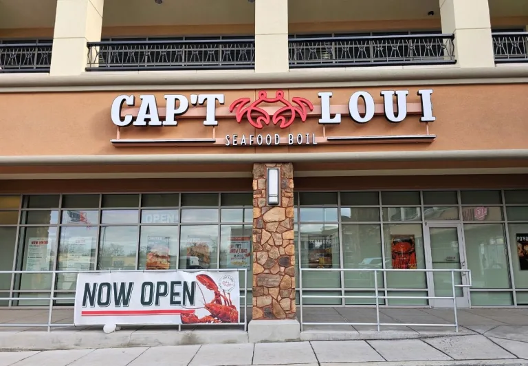 Storefront of Capt Loui seafood restaurant fitted with commercial window shades