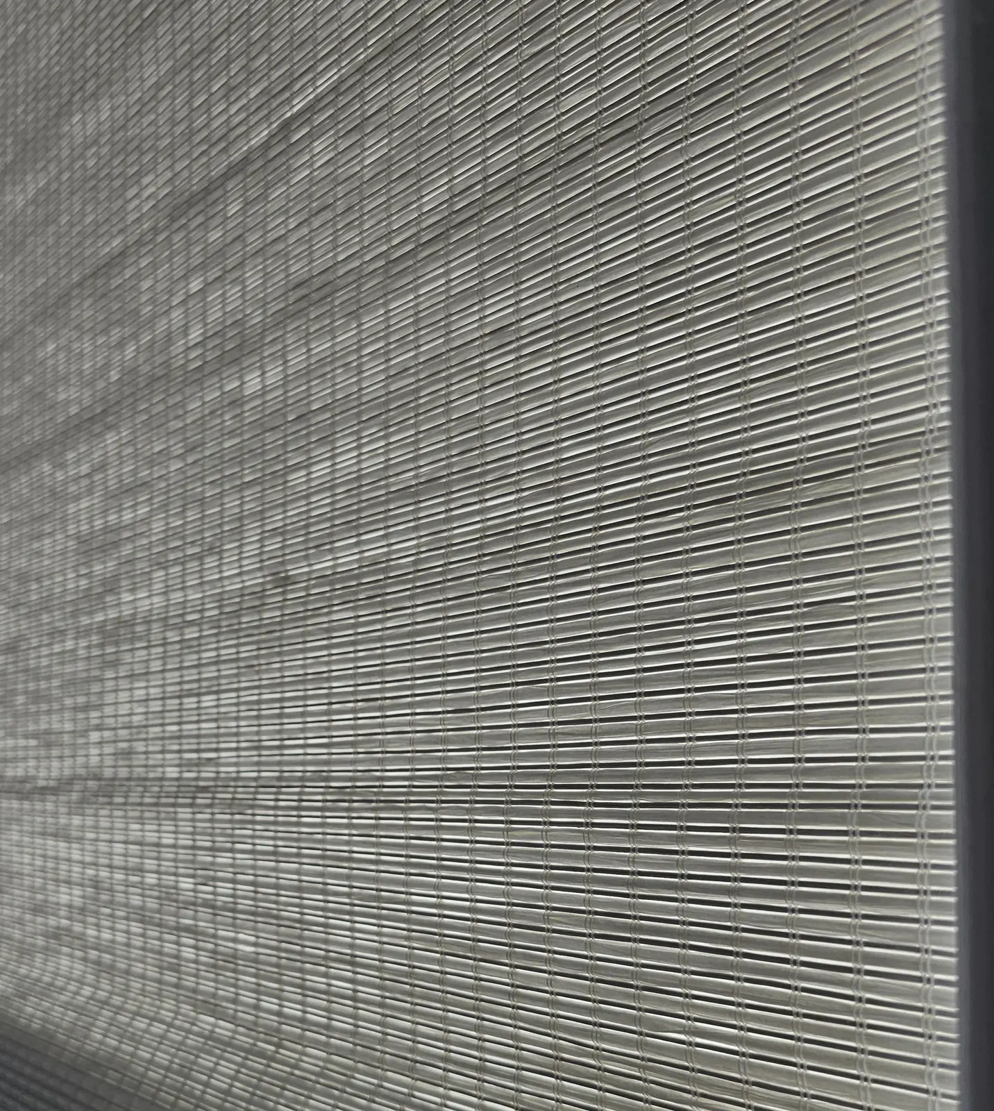 Close-up of the natural fiber weave on a woven wood shade